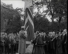 British Officer Pulling Down Union Flag to Reveal a Memorial Obelisk, 1920. Creator: British Pathe Ltd.