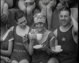 British People Sitting Around and Drinking Cups of Tea While Wearing Bathing Suits at the.., 1920. Creator: British Pathe Ltd.