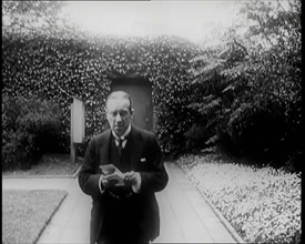 Prime Minister of Britain, Stanley Baldwin, Walking in the Gardens at Chequers Whilst Reading, 1926. Creator: British Pathe Ltd.