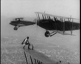 A Wing Walking Female Civilian Changes the Wheel of an Aeroplane in Flight, 1926. Creator: British Pathe Ltd.