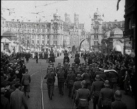 German Soldiers Marching Down a Street as a Crowd Watches, 1930s. Creator: British Pathe Ltd.