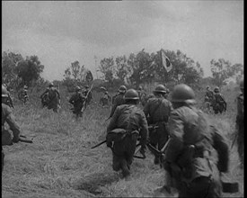 Japanese Soldiers Running Through a Field, 1933. Creator: British Pathe Ltd.