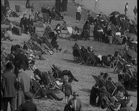 A Crowd of Civilians Sitting on Deckchairs at the Beach, 1926. Creator: British Pathe Ltd.