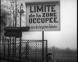 A Sign Read 'Limite de la Zone Occupee. Grenze des Besetzten Gebietes', a French Soldier..., 1924. Creator: British Pathe Ltd.