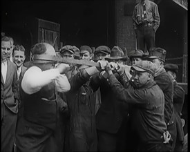 A Male Stuntman Bending Iron Bars Around His Head, 1926. Creator: British Pathe Ltd.