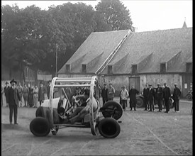 A Crashable Car With a Circular Frame Allowing It To Roll Over Being Tested in Front of..., 1926. Creator: British Pathe Ltd.