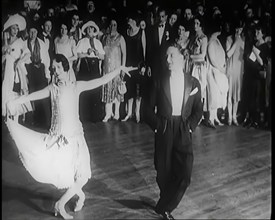 Female Civilian and Male Civilian Dancing in Front of a Crowd of People, 1926. Creator: British Pathe Ltd.