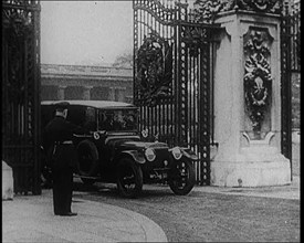 A Uniformed Male and a Male British Police Officer Standing Outside the Gates of Buckingham..., 1924 Creator: British Pathe Ltd.