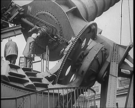 Large Telescope Being Turned by Two Civilians, 1931. Creator: British Pathe Ltd.