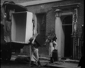 Two Male Civilians Load Furniture Into a Van Outside of 10 Downing Street, 1924. Creator: British Pathe Ltd.