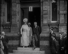 Queen Mary Accompanied by a Group of Officials Emerging from a Building , 1924. Creator: British Pathe Ltd.