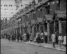 People Out the Front of Their Houses in a Street Decorated With Union Flag Bunting in Belfast, 1921. Creator: British Pathe Ltd.