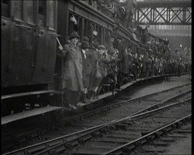 French People Hanging Onto the Outside of a Packed Train as It Drives Along, 1920. Creator: British Pathe Ltd.