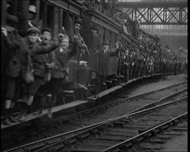 French People Hanging Onto the Outside of a Packed Train as It Drives Along, 1920. Creator: British Pathe Ltd.