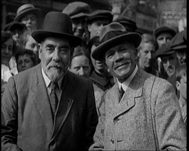 Two Labour Politicians Talking to Each Other, Surrounded by Supporters, 1921. Creator: British Pathe Ltd.