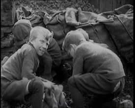 Male Children Picking Through Small Heaps of Coal on the Ground , 1924. Creator: British Pathe Ltd.