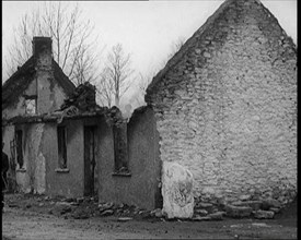 A Man Standing Outside a Burnt Out Cottage in Ireland, Holding a Bicycle, 1921. Creator: British Pathe Ltd.