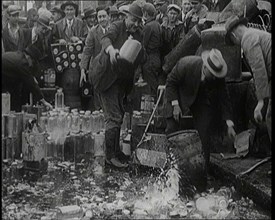 Prohibition Scenes in the United States of America. Men Smashing Bottles of Alcoholic..., 1920. Creator: British Pathe Ltd.