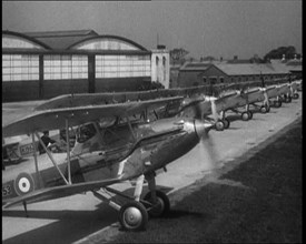 RAF Biplanes Taxiing Across a Field at tended to by Their Aircrews, 1933. Creator: British Pathe Ltd.