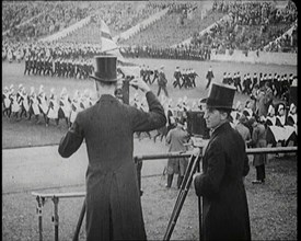 Male Newsreel Camera Operators Carrying Tripods and Equipment, 1920s. Creator: British Pathe Ltd.