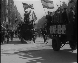 Male Civilians Driven in Trucks Parade Waving Flags. Other Male Civilians Ride Alongside on..., 1924 Creator: British Pathe Ltd.