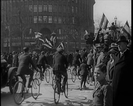 Male Civilians Driven in Trucks Parade Waving Flags. Other Male Civilians Ride Alongside on..., 1924 Creator: British Pathe Ltd.