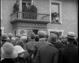 British Man Speaking to a Crowd from the Balcony of a Building Marked 'Feathers J. Davies..., 1921. Creator: British Pathe Ltd.