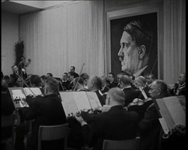 Orchestra Playing with a Portrait of Adolf Hitler in the Background, 1930s. Creator: British Pathe Ltd.