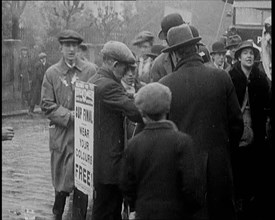 A Man Wearing a Sandwich Board Advertising 'Pathe Gazette' Reading 'Cup Final Wear Your..., 1921. Creator: British Pathe Ltd.