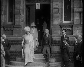 Queen Mary Accompanied by a Group of Officials Emerging from a Building , 1924. Creator: British Pathe Ltd.