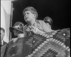 King Michael of Romania  Leans Over a Balcony. Behind Him are Two Female Civilians, 1924. Creator: British Pathe Ltd.