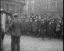 British Soldiers Standing by a Tank in a German Town as Civilians Look On, 1921. Creator: British Pathe Ltd.