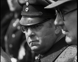 Three Men in a Crowd Listening to a Speech, 1930s. Creator: British Pathe Ltd.