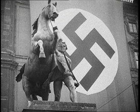 Statue With a Nazi Flag Behind it, 1930s. Creator: British Pathe Ltd.