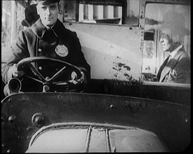 Male Bus Driver Sitting in the Cabin of a Bus, 1922. Creator: British Pathe Ltd.