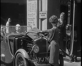 Female Civilians Working Petrol Pumps in a Garage and Filling up a Car, 1931. Creator: British Pathe Ltd.