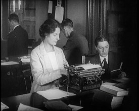 Journalists at Work Typing, Reading, and Making Notes. a Woman Is Typing What Is Being..., 1921. Creator: British Pathe Ltd.