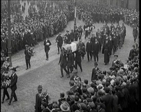 Huge Crowds Watching the Funeral Procession of Terence MacSwiney. His Coffin Is Draped..., 1920. Creator: British Pathe Ltd.