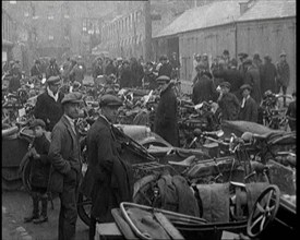 Men Standing Around Groups of Motorcars and Motorbikes, 1920. Creator: British Pathe Ltd.