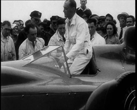 Malcolm Campbell Entering a Car While a Crowd Watches, 1933. Creator: British Pathe Ltd.