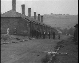 Group of Men, Women and Children Standing Around on a Street, 1933. Creator: British Pathe Ltd.