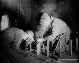 Two Men Working in a Factory, 1933. Creator: British Pathe Ltd.