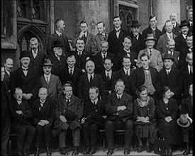 Prime Minister Ramsay MacDonald Sitting on a Chair Smoking Whilst Surrounded by Members of..., 1924. Creator: British Pathe Ltd.