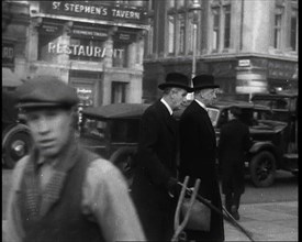 Two Male Politicians Walking Along a Busy Bridge Street Towards the Palace of Westminster, 1937. Creator: British Pathe Ltd.