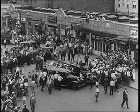 Crowded New York City Street Where Police and Ambulance Attend to Dead and Dying Victims..., 1932. Creator: British Pathe Ltd.