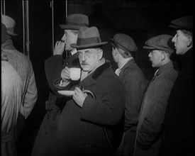 Author Sir James Barrie Drinking a Cup of Tea Surrounded By Male Civilians, 1924. Creator: British Pathe Ltd.