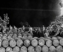 Commonwealth Troops Walking Through a Flaming Supply Dump, 1941. Creator: British Pathe Ltd.