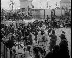 A Crowd of People Watch as Others Ride a Model Train Which Passes Them, 1924. Creator: British Pathe Ltd.