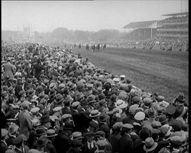 A Crowd of People Watching Horses Racing at Ascot Race Track, 1924. Creator: British Pathe Ltd.