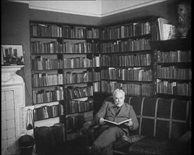 C.E.M Joad Reading a Book, 1930s. Creator: British Pathe Ltd.